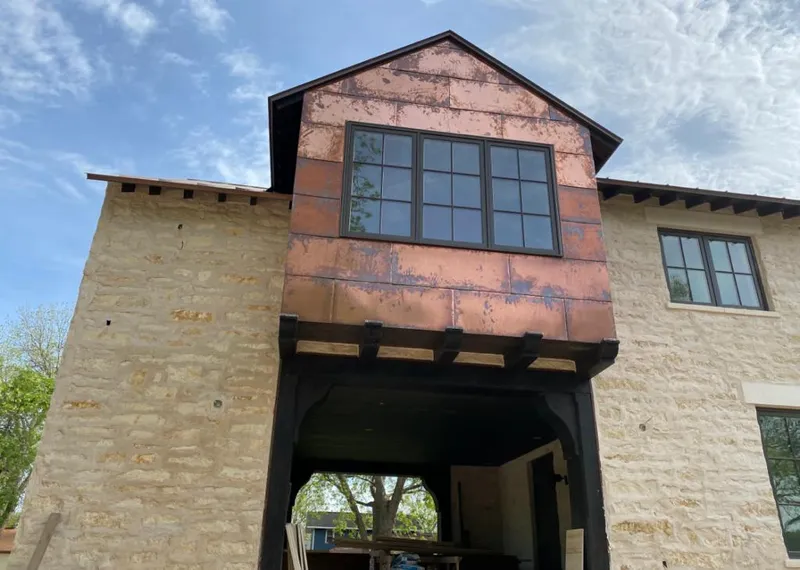 Copper metal panel facade on a stone building for Roof Repair in Little Chute